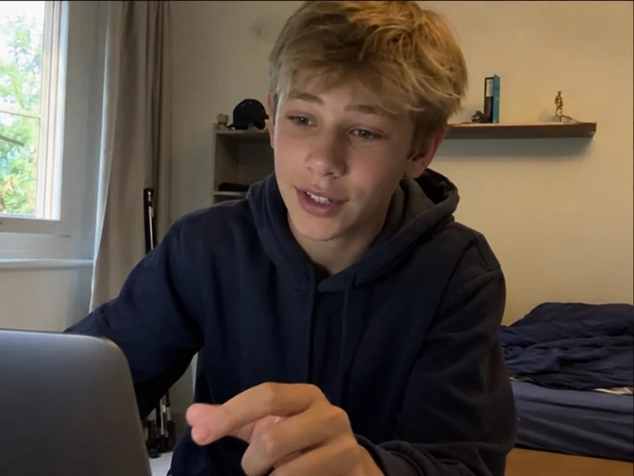 A student recording a daily progress vlog at his laptop