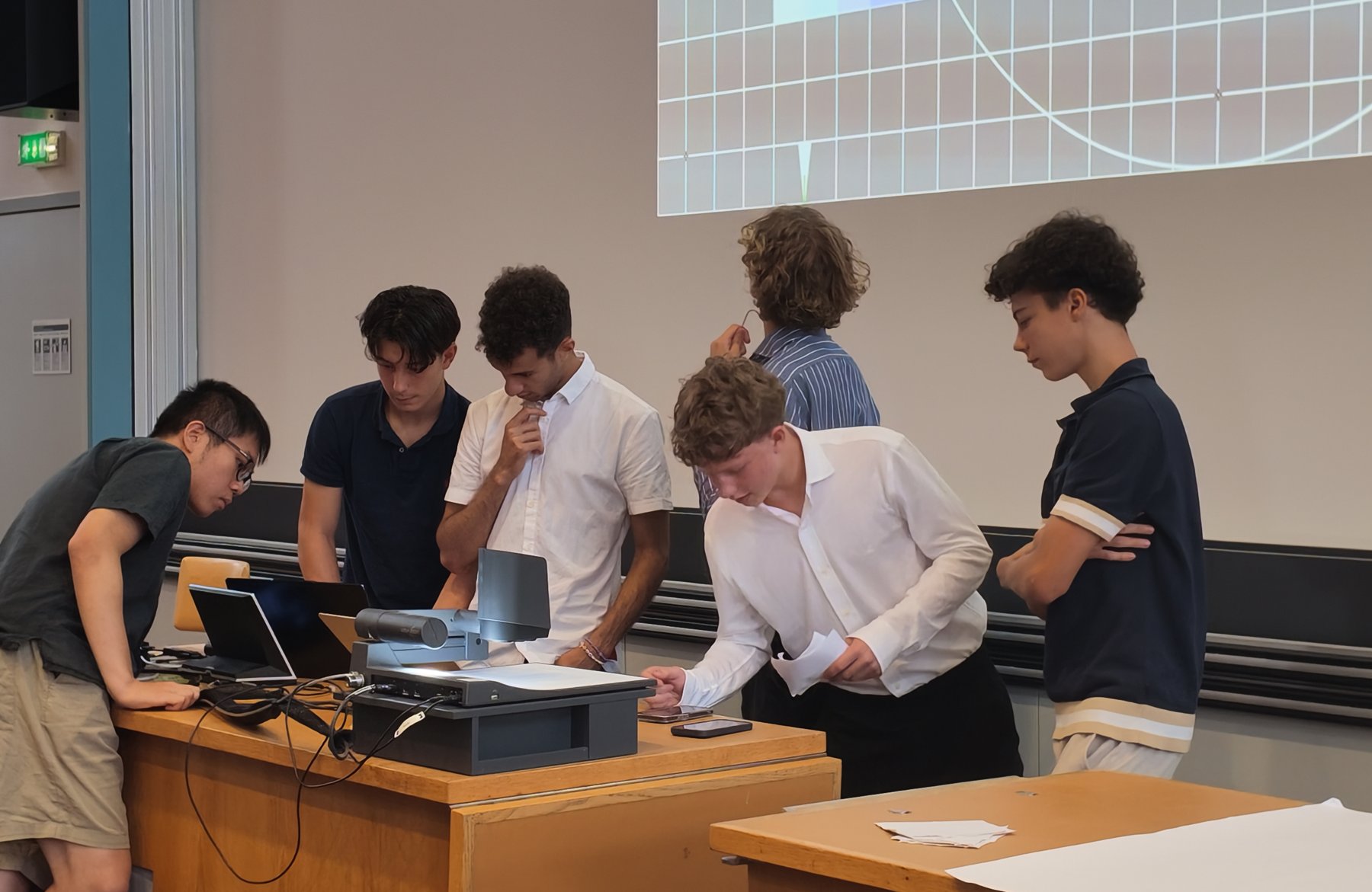 Camp students building a project together around a table